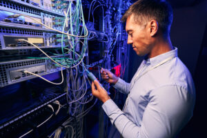 System administrator doing diagnostic tests on computer servers