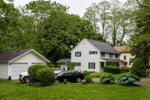 Typical American Residential House Building With American Flag A