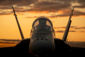 Fighter jet silhouette at sunset
